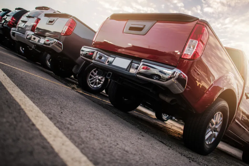 View from below of row of parked trucks in lot